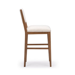 Elegant wooden barstool with white cushion, side view.