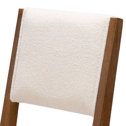 Rustic wooden chair with cream cushioned backrest for modern dining room decor.