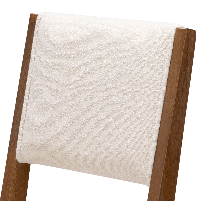 Rustic wooden chair with cream cushioned backrest for modern dining room decor.