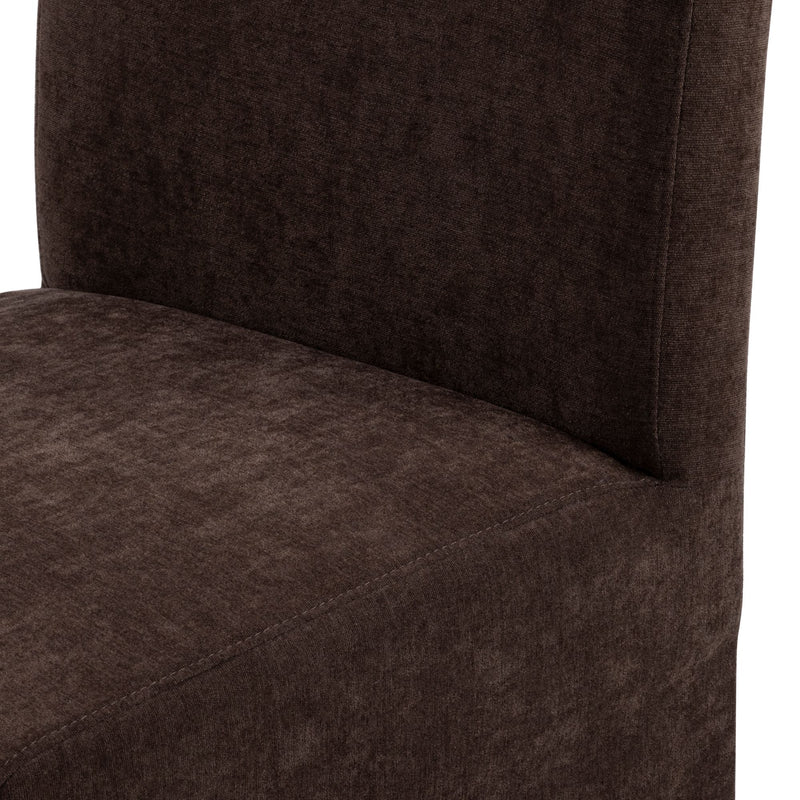 Close-up of chocolate brown upholstered dining chair seat and back showing soft textured fabric and visible seam stitching, modern armless design