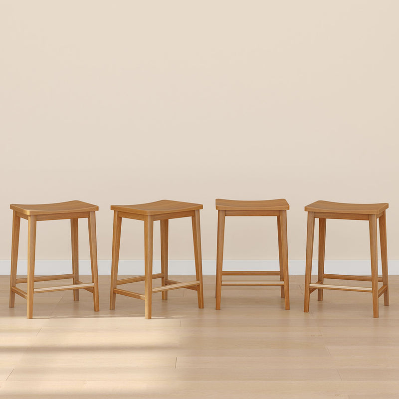 Four wooden stools arranged in a row on a light wood floor with a neutral beige background.