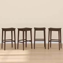 Four dark wooden bar stools with sleek design on light hardwood floor.