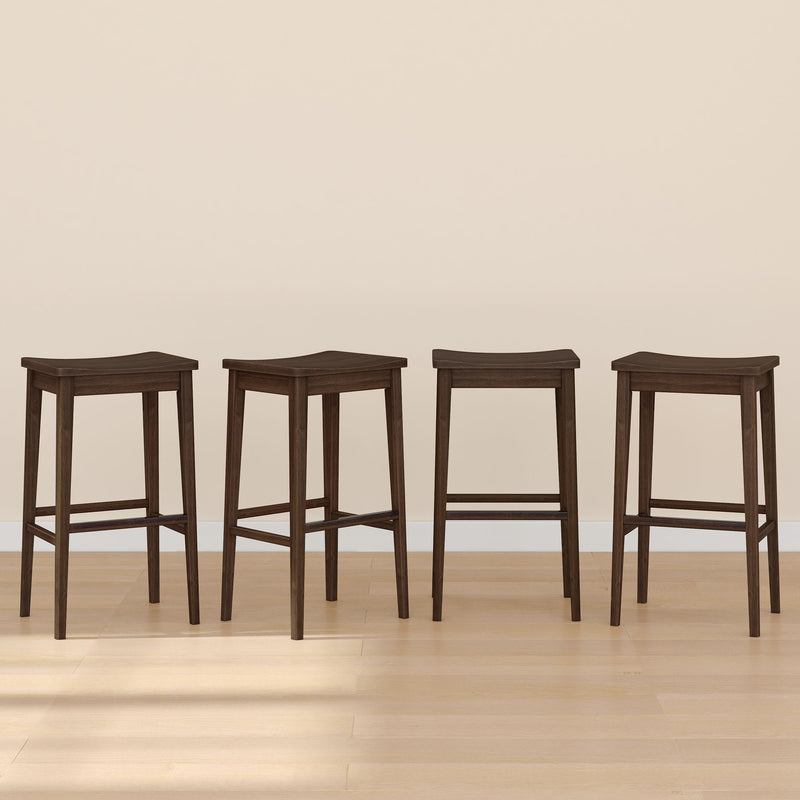 Four dark wooden bar stools with sleek design on light hardwood floor.