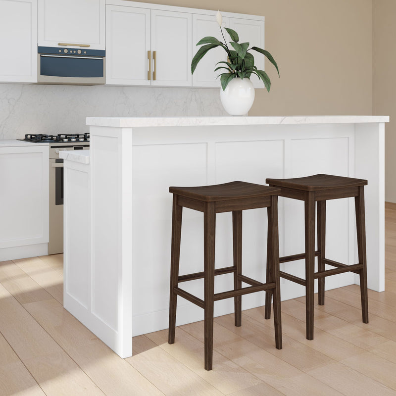 Modern kitchen with white cabinets, marble countertop, and two dark wooden bar stools.