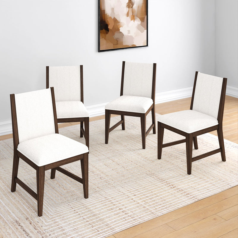 Four modern dining chairs with white upholstery and dark wooden frames on a light-patterned rug in a contemporary dining room.