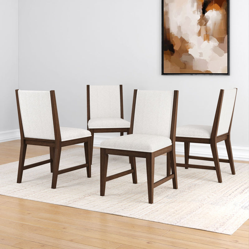 Mid-century modern dining chairs with white upholstery and dark wood frames on a light rug in a minimalist room.