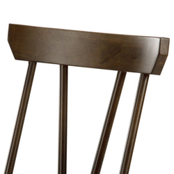 Dark wooden chair backrest with vertical slats, showcasing modern design and craftsmanship.