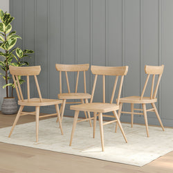 Set of four modern wooden chairs on a beige rug, ideal for contemporary dining rooms.