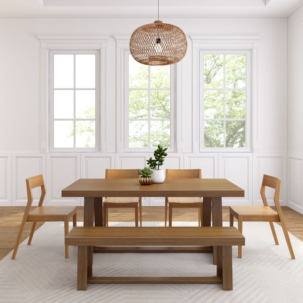 Modern dining room with wooden table, chairs, and bench, featuring a woven pendant light and potted plant, complemented by large windows.