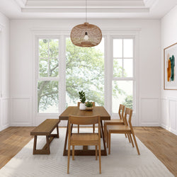 Modern dining room with wooden table, chairs, and large windows overlooking lush greenery.