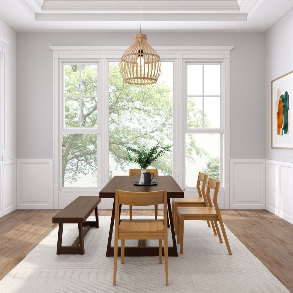 Modern dining room with wooden table and chairs, pendant light fixture, and large windows showcasing natural light.