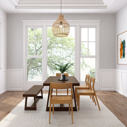 Modern dining room with wooden table and chairs, pendant light fixture, and large windows showcasing natural light.