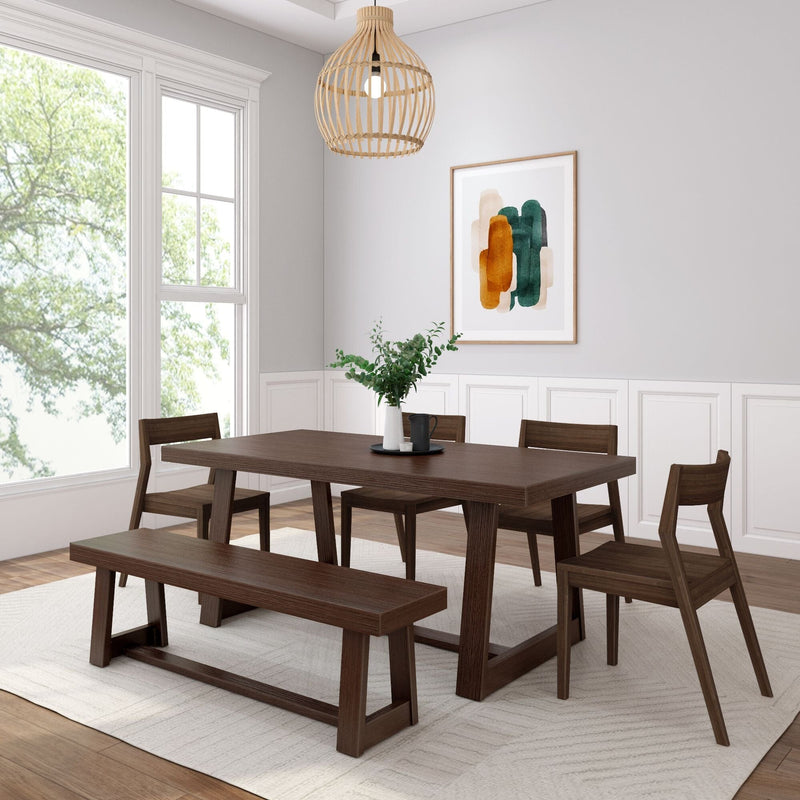 Modern farmhouse dining room with dark solid wood table, bench and chairs, rattan pendant light, abstract wall art and large window with natural light.
