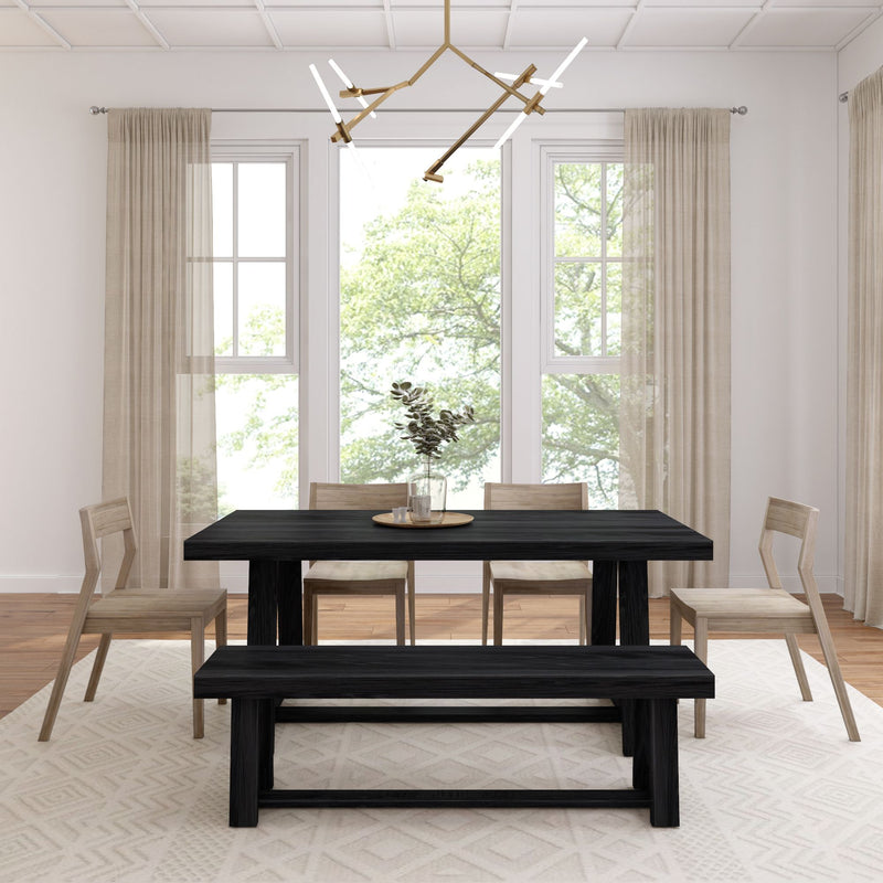 Modern dining room with black table, wooden chairs, and large windows showcasing natural light.
