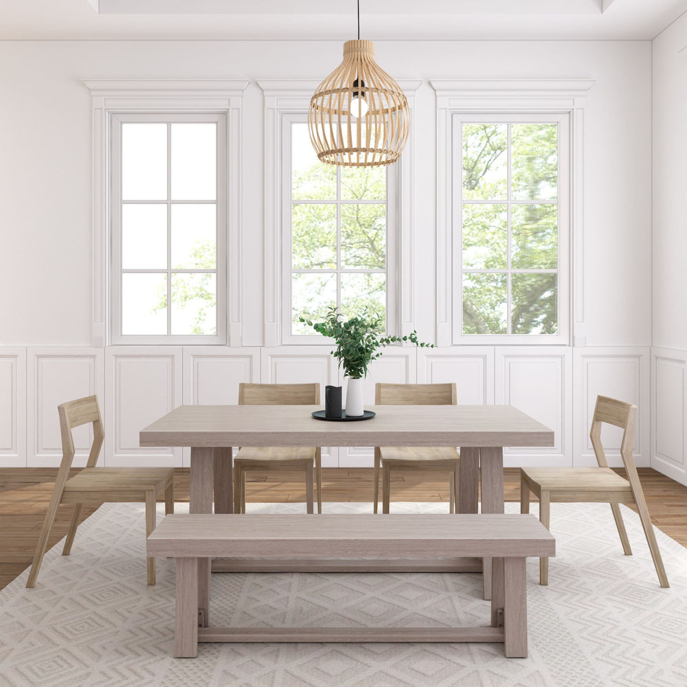 Modern minimalist dining room with light wood furniture, neutral decor, and large windows.