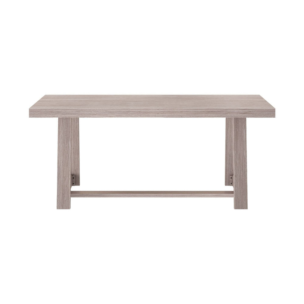 Modern wooden dining table with a light oak finish and sturdy legs.