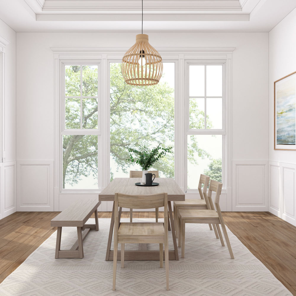 Bright dining room with modern wooden table, chairs, and pendant light against large windows.