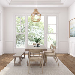 Bright dining room with modern wooden table, chairs, and pendant light against large windows.