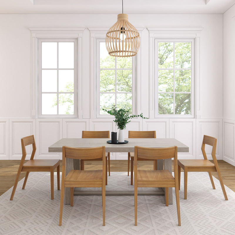 Modern dining room with wooden chairs, rectangular table, and pendant light fixture.