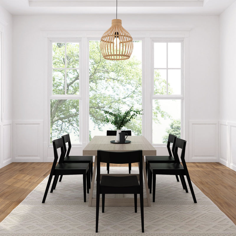 Modern dining room with wooden table, black chairs, large windows, and woven pendant light.