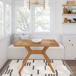 Cozy dining nook with wooden table, modern chandelier, and decorative pillows for a stylish and versatile kitchen space.
