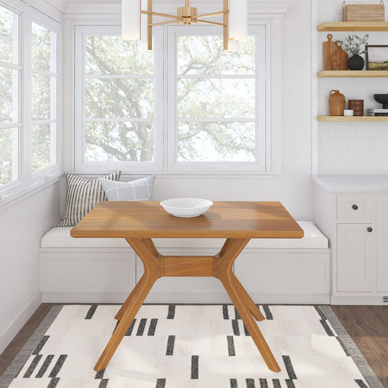 Cozy dining nook with wooden table, modern chandelier, and decorative pillows for a stylish and versatile kitchen space.