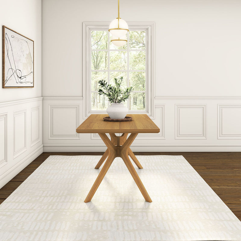 Modern dining room with wooden table, potted plant, and abstract wall art in a bright interior space.