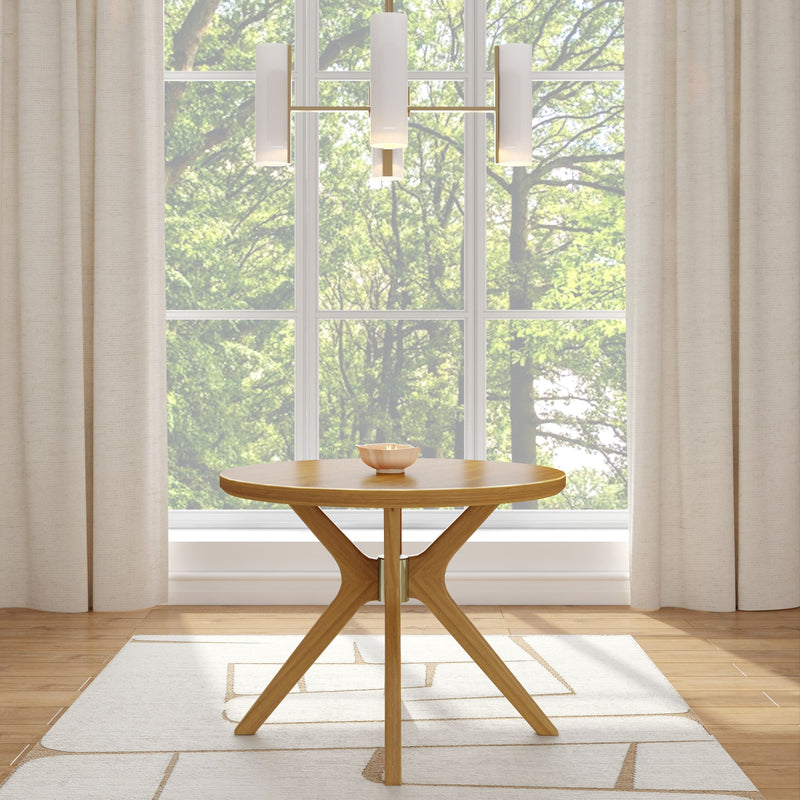 Modern round wooden table in a bright room with large windows and cream curtains, featuring a minimalist pendant light and scenic outdoor view.