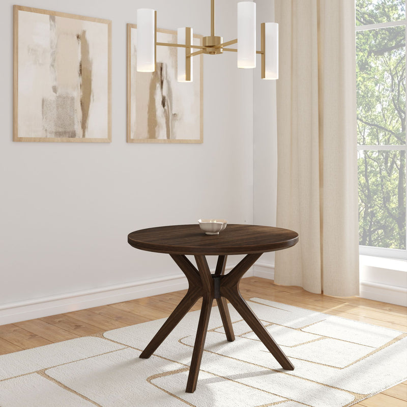Modern round wooden dining table with elegant chandelier and abstract wall art in a bright minimalist room.