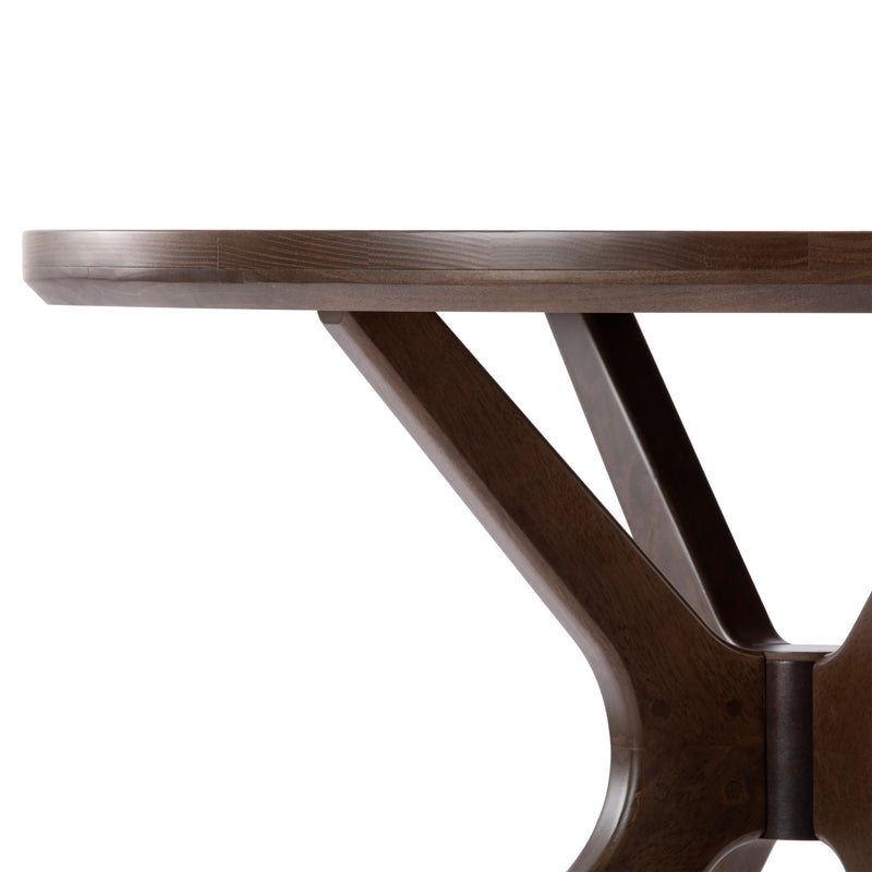 Round wooden dining table with modern dark wood finish and sleek pedestal base design.