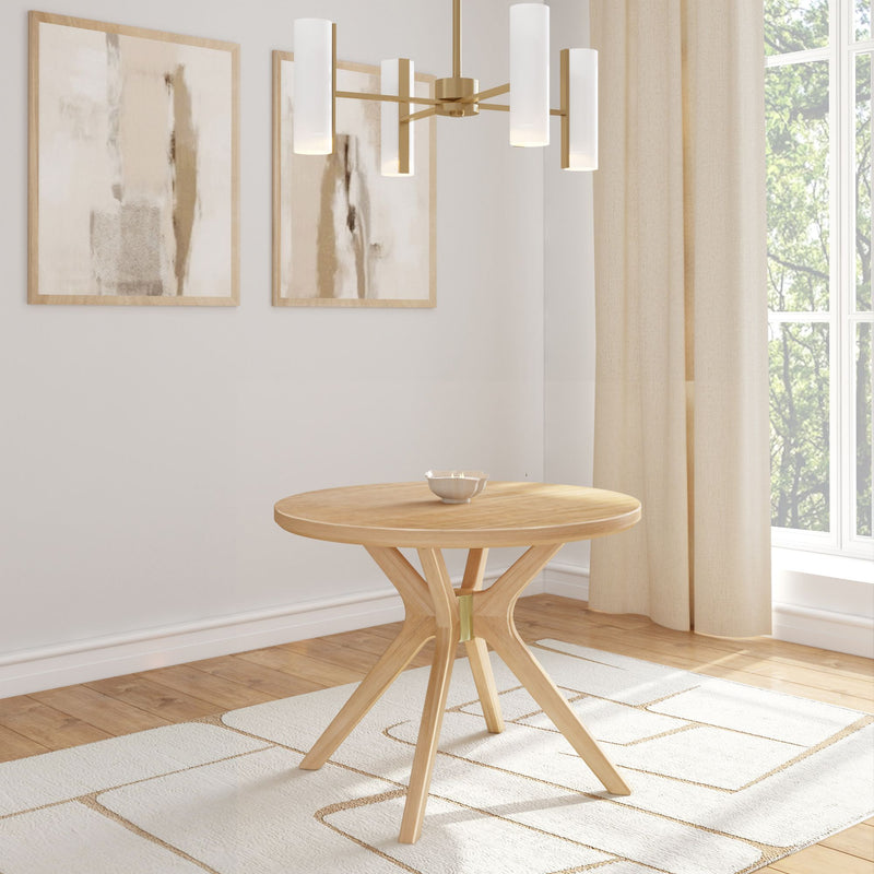 Modern dining room with round wooden table, elegant chandelier, abstract wall art, and large window.