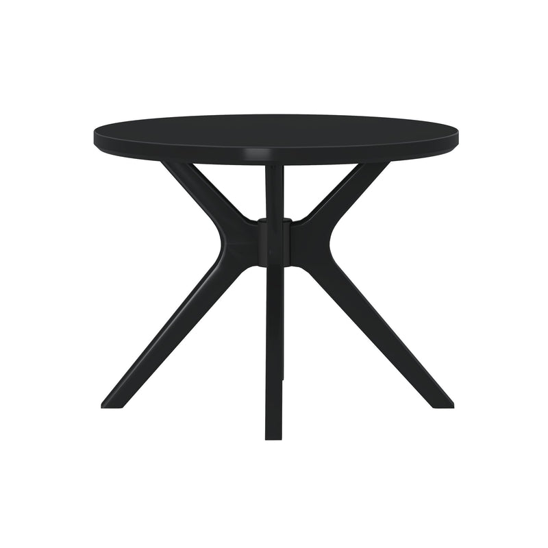 Round black modern dining table with four legs for contemporary interior design.