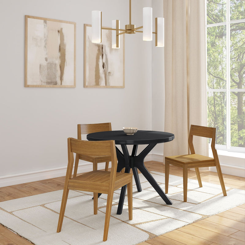 Modern dining room with round black table, wooden chairs, and minimalist art on the wall.