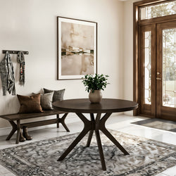 Modern neutral foyer with round dark wood entry table and potted plant, wooden bench with cushions, abstract wall art and glass‑panel front door