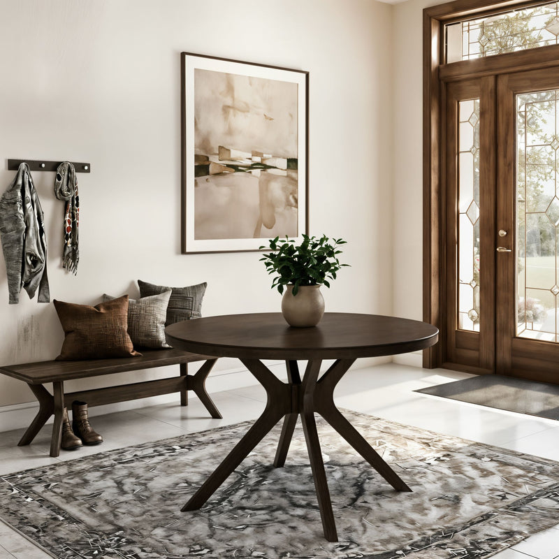Modern neutral foyer with round dark wood entry table and potted plant, wooden bench with cushions, abstract wall art and glass‑panel front door