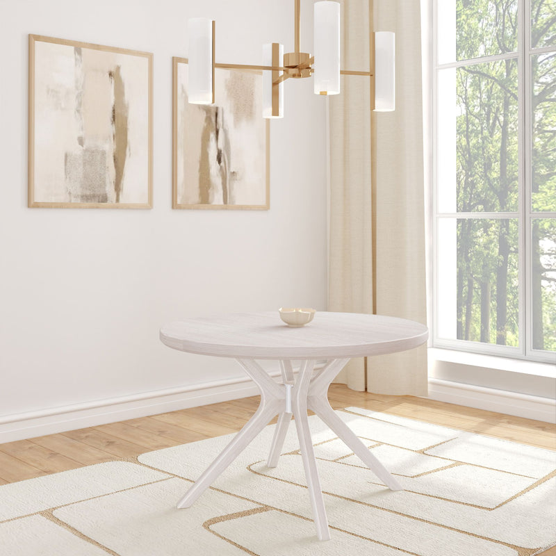 Minimalist dining room with round wooden table, modern chandelier, abstract wall art, and large window with natural light.