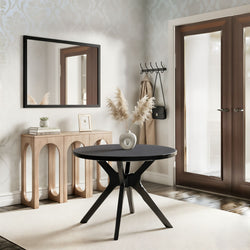 Modern neutral entryway with round black table, wooden console, large rectangular wall mirror, pampas grass vase, wall coat rack and glass double doors