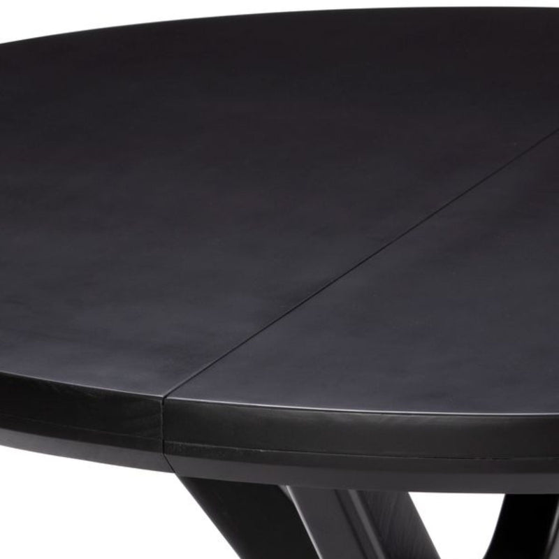 Close-up of black round plastic patio table top showing center seam and angled leg, expandable outdoor garden table