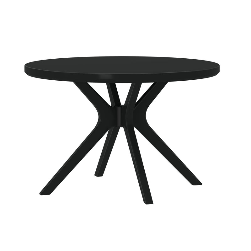 Modern black round dining table with sculptural spider-leg base and matte finish, contemporary dining furniture