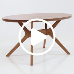 Round wooden dining table with a modern design and sturdy legs.