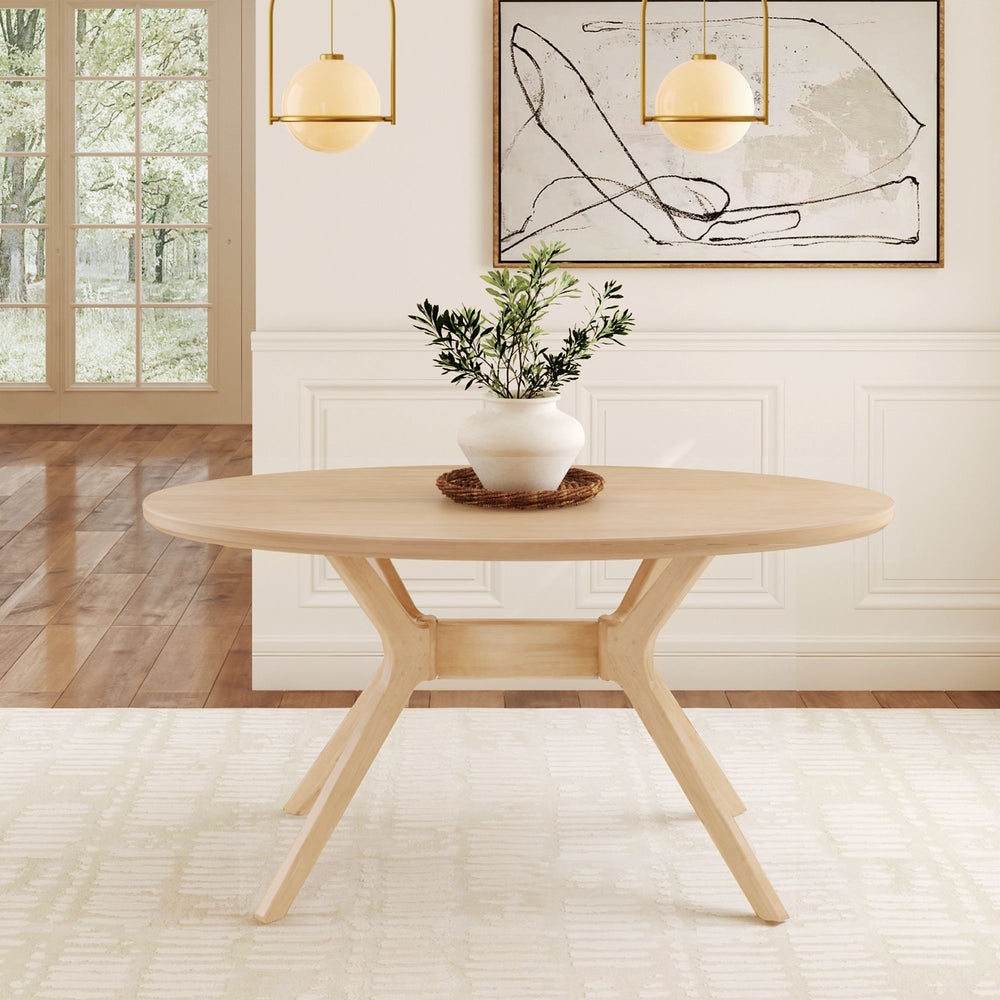 Oval wooden dining table with modern design in a bright minimalist dining room, featuring a potted plant centerpiece and abstract wall art.