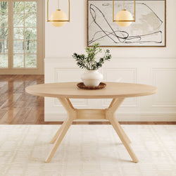 Oval wooden dining table with modern design in a bright minimalist dining room, featuring a potted plant centerpiece and abstract wall art.