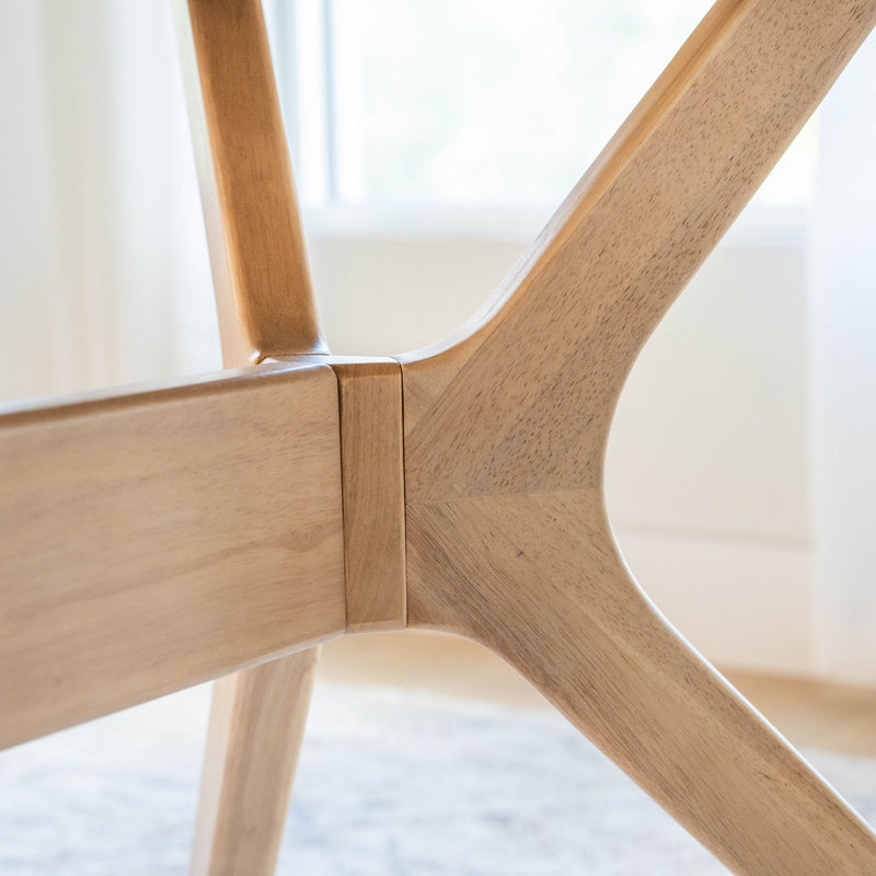 Close-up view of modern wooden table leg design in natural light.