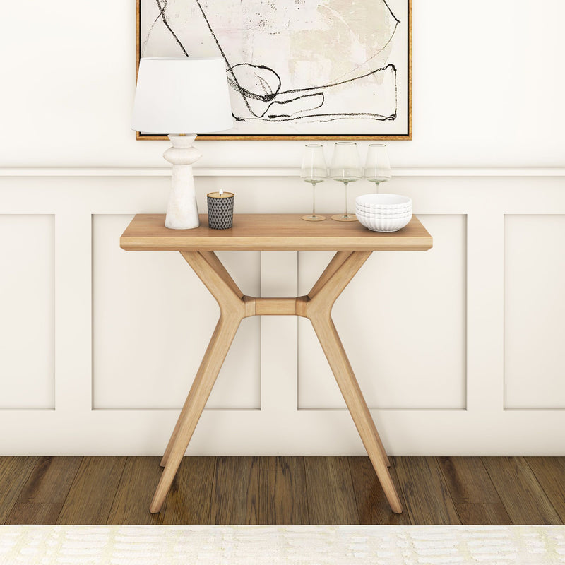 Stylish modern wooden console table with decorative elements against a white paneled wall in a minimalist interior design setting.