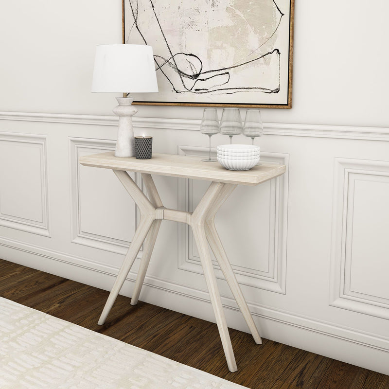 Modern white console table with decorative items against a paneled wall in a stylish living room.