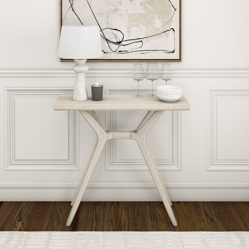 Elegant modern console table with decorative items and minimalist wall art.