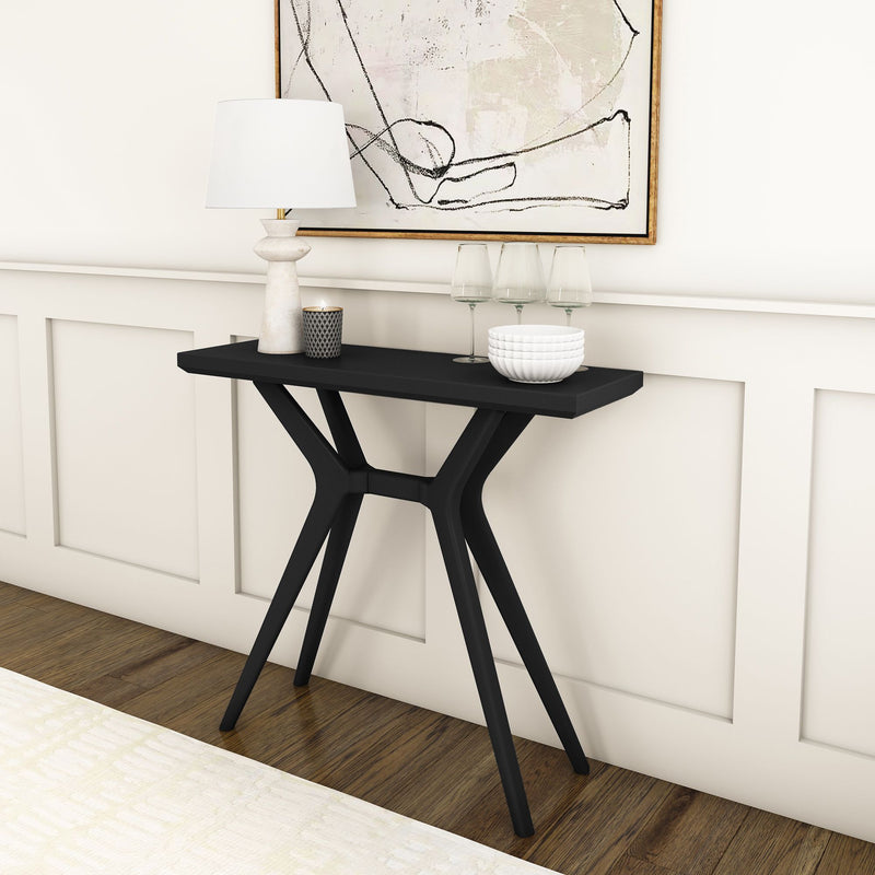 Black modern console table with decorative items in minimalist living room interior.
