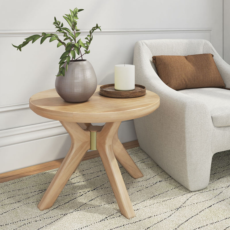 Modern living room with a stylish side table, elegant vase with greenery, a cozy armchair, and a decorative candle.