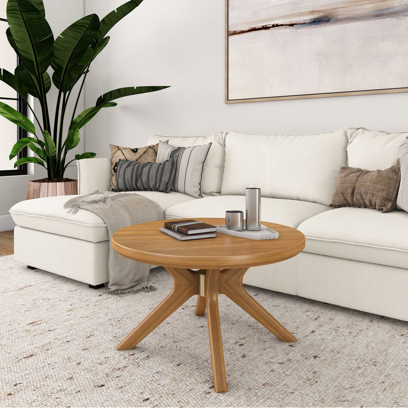 Modern living room with white sectional sofa, wooden coffee table, and indoor plant.