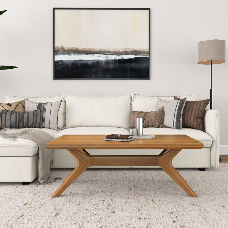 Modern living room with cream sofa, wooden coffee table, and abstract wall art.